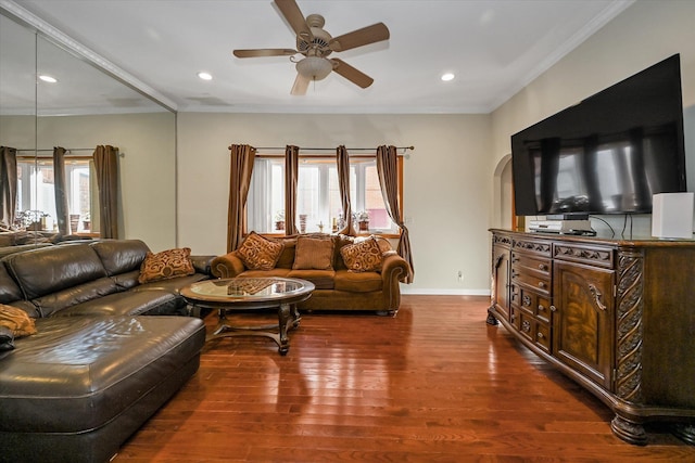 living room featuring ornamental molding, a healthy amount of sunlight, dark wood-type flooring, and ceiling fan