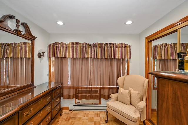 sitting room featuring a baseboard radiator and light parquet flooring