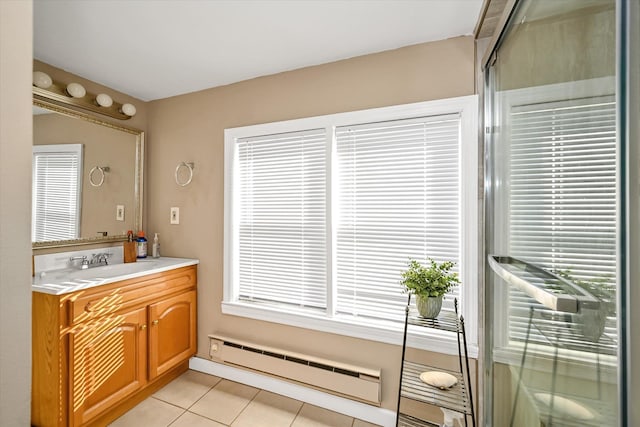 bathroom with tile patterned flooring, vanity, an enclosed shower, and baseboard heating