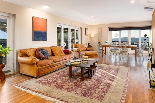 living room with wood-type flooring and french doors