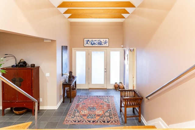 tiled entrance foyer featuring french doors and a high ceiling