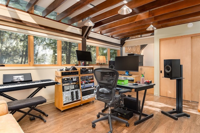 office space with beam ceiling and light wood-type flooring