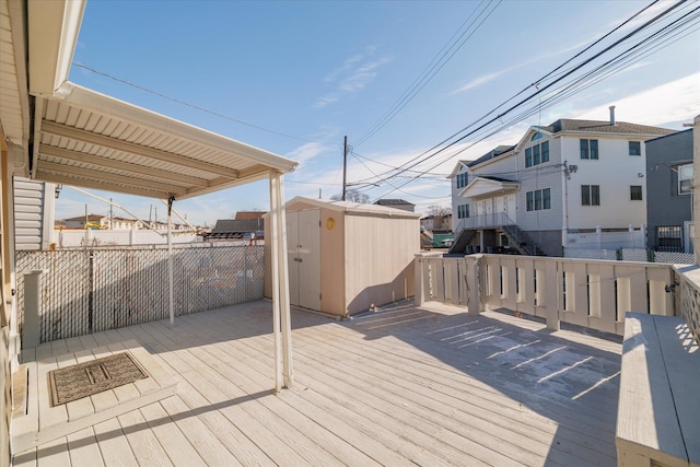 wooden deck with a storage shed