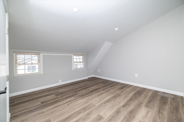 bonus room featuring wood-type flooring and lofted ceiling