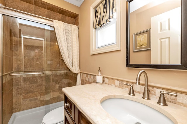 bathroom featuring vanity, toilet, and an enclosed shower