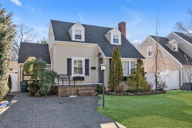 new england style home featuring a patio and a front yard