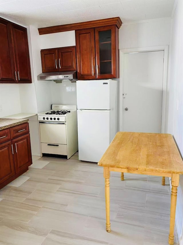 kitchen with white appliances and light stone countertops