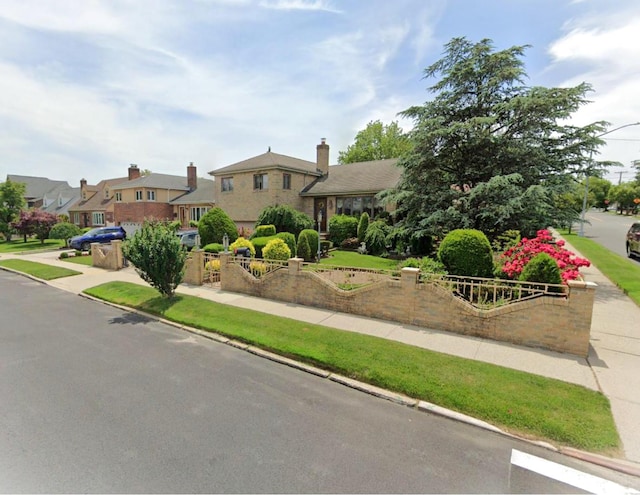 view of front of home featuring stone siding and a residential view