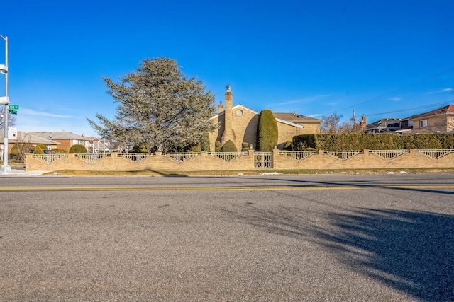 view of street with a residential view and curbs