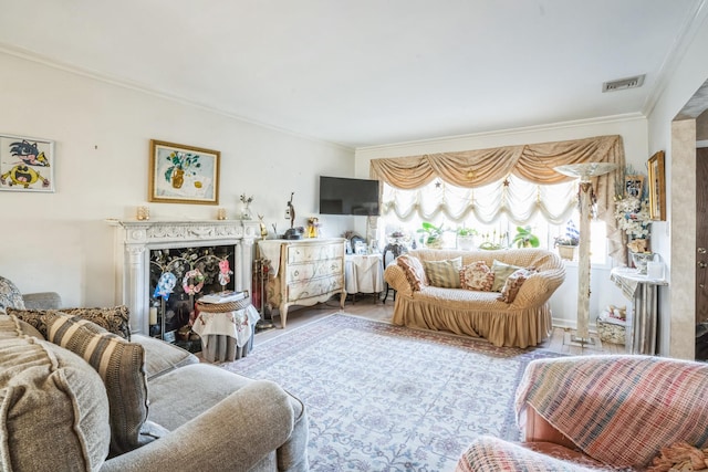 living room with a fireplace, visible vents, and crown molding