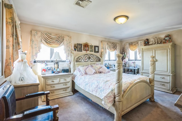 bedroom with dark carpet, visible vents, and crown molding