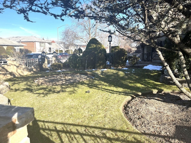 view of yard with a residential view and fence