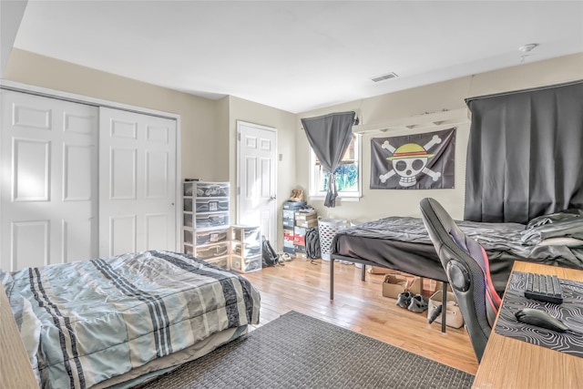 bedroom with wood-type flooring and a closet