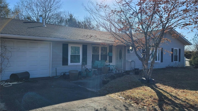 single story home featuring a garage and covered porch