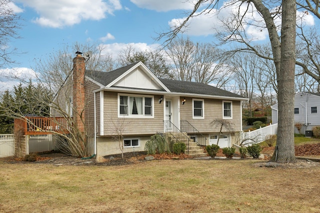 bi-level home featuring a garage and a front yard