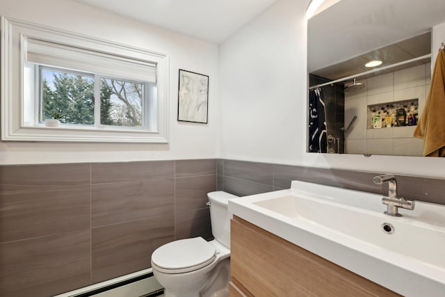 bathroom with curtained shower, a baseboard radiator, tile walls, vanity, and toilet