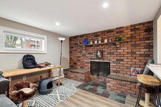 interior space featuring a fireplace, a baseboard radiator, and hardwood / wood-style floors