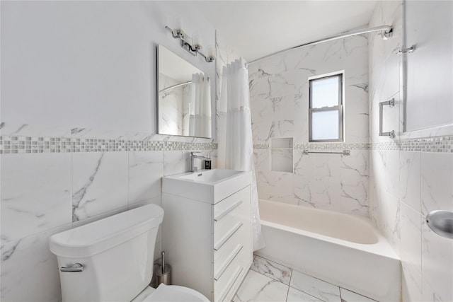 full bathroom featuring shower / bath combo, toilet, marble finish floor, vanity, and tile walls