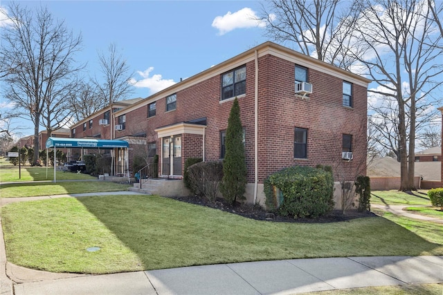 view of home's exterior with brick siding and a lawn