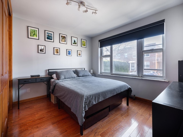 bedroom with hardwood / wood-style flooring