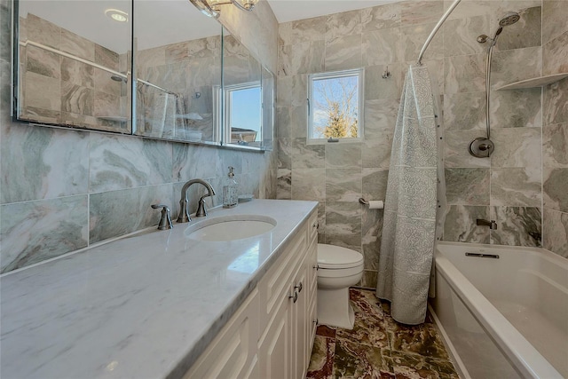 full bathroom with toilet, vanity, shower / bathtub combination with curtain, and tile walls