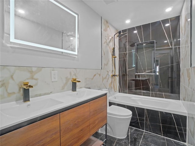 full bathroom with vanity, tiled shower / bath combo, and toilet