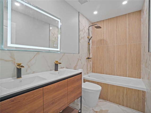 full bathroom with vanity, tiled shower / bath combo, tile walls, and toilet