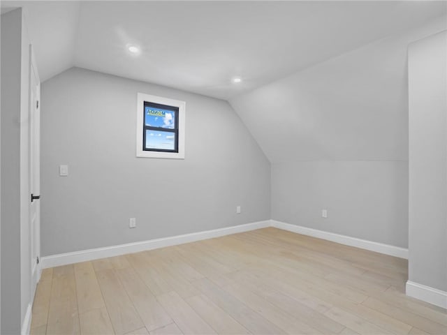 bonus room with light hardwood / wood-style floors and vaulted ceiling