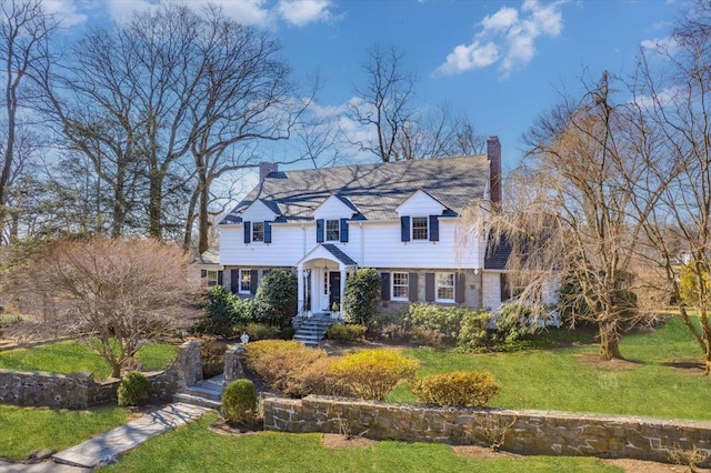 view of front of home with a front yard and a chimney