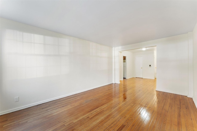 unfurnished room with wood-type flooring