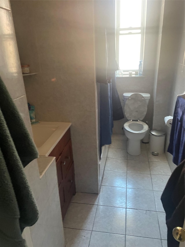 bathroom featuring tile patterned flooring, vanity, and toilet