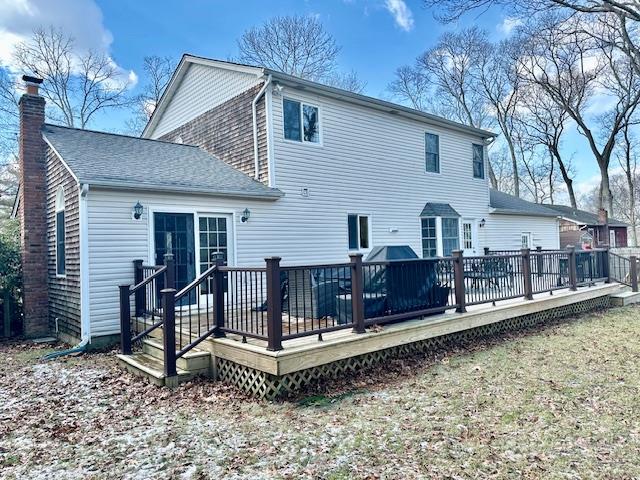 back of house featuring a deck