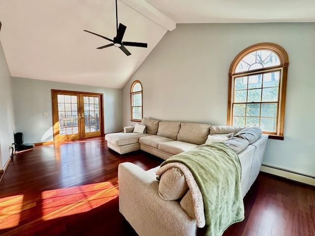 living room featuring lofted ceiling with beams, a baseboard radiator, ceiling fan, dark wood-type flooring, and french doors