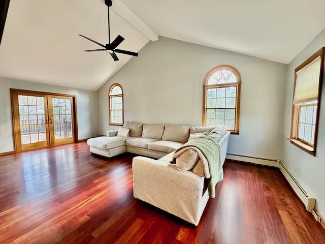 living room with vaulted ceiling with beams, baseboard heating, ceiling fan, dark wood-type flooring, and french doors