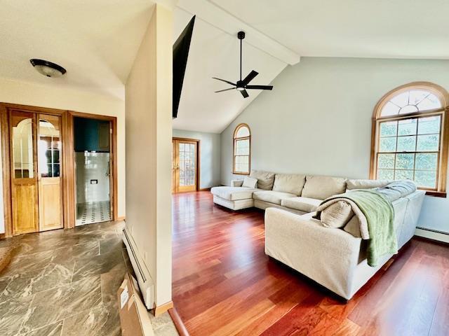 living room featuring dark hardwood / wood-style flooring, a baseboard heating unit, lofted ceiling with beams, and ceiling fan