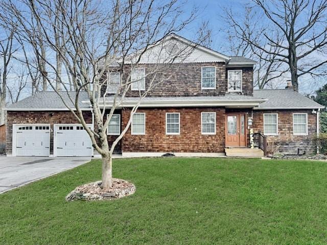 view of front of house featuring a garage and a front lawn