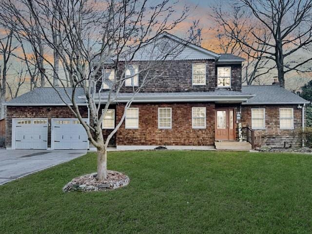 view of front facade with a garage and a lawn