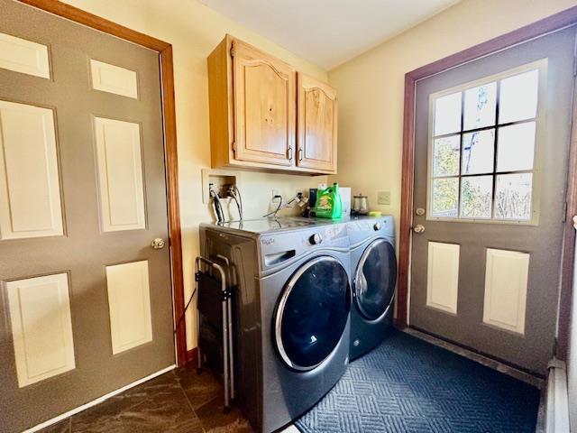 washroom featuring cabinets and washing machine and clothes dryer