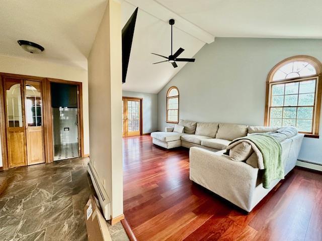 living room featuring ceiling fan, a baseboard radiator, dark hardwood / wood-style flooring, and lofted ceiling with beams