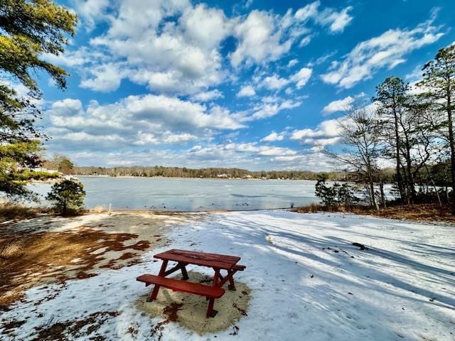 snowy yard with a water view