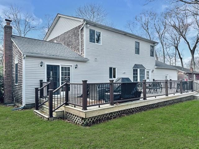 back of house with a lawn and a deck