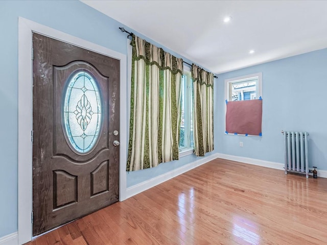 foyer entrance with radiator and light hardwood / wood-style floors