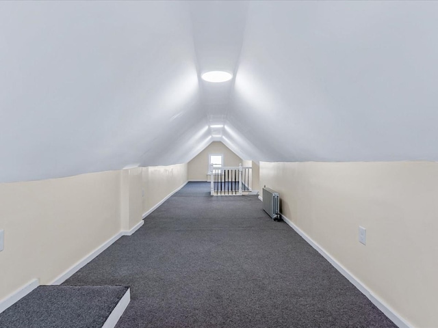 bonus room featuring vaulted ceiling and radiator