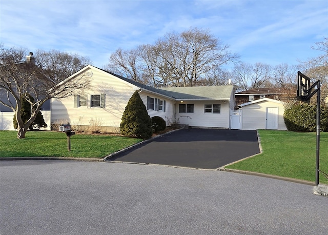 ranch-style house with a front yard and a shed