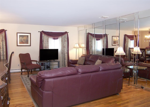 living room featuring hardwood / wood-style flooring and a notable chandelier