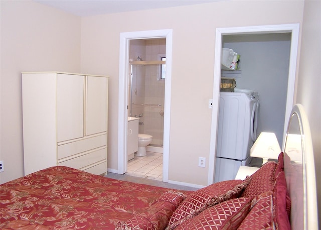 bedroom featuring connected bathroom, washer / clothes dryer, and light tile patterned floors