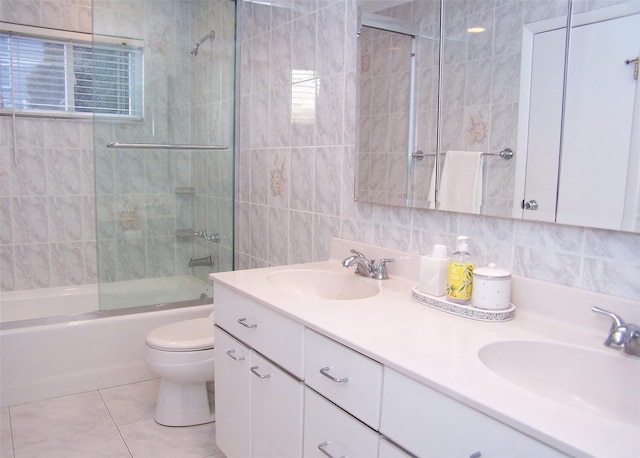 full bathroom with tile patterned flooring, enclosed tub / shower combo, tile walls, and vanity