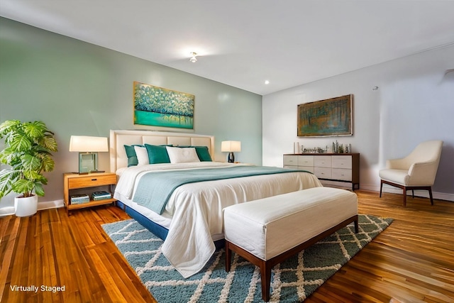bedroom featuring baseboards and wood finished floors