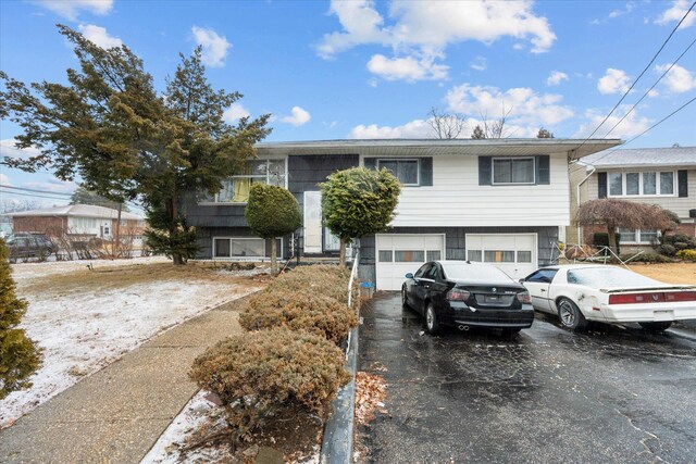 view of front of property with aphalt driveway and an attached garage