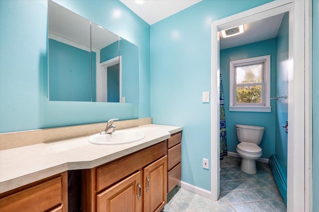 bathroom with vanity, tile patterned flooring, toilet, and baseboard heating